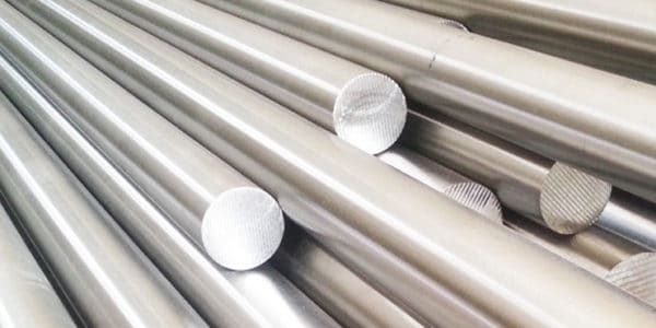 Here's an alt tag for the image: `Stacked metal rods`