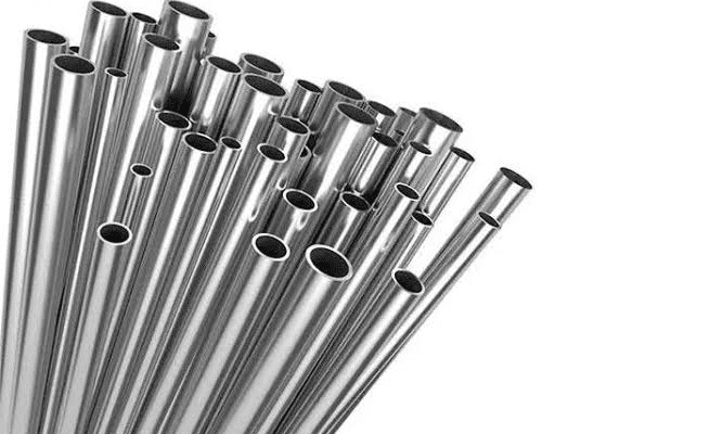 Here's an alt tag for the image: Pile of shiny metal pipes.
