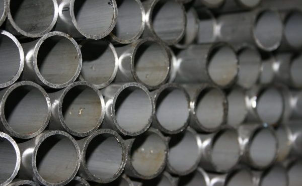 Here's an alt tag for the image: Stack of metal pipes